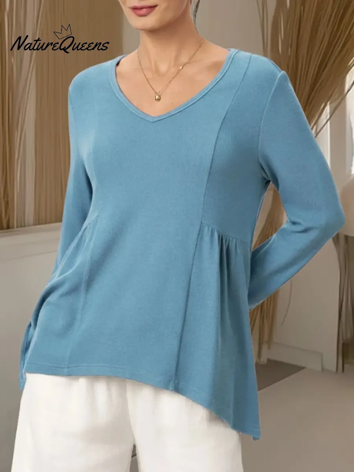 Women's Solid Color V-neck Long-sleeved Casual Loose-fitting Top With Irregular Hem.
