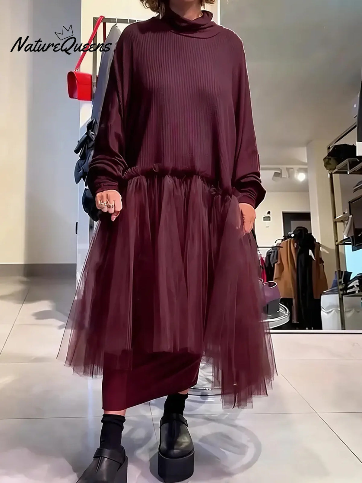 Women's solid color stand-collar long-sleeved casual loose-fitting knitted dress with mesh paneling.