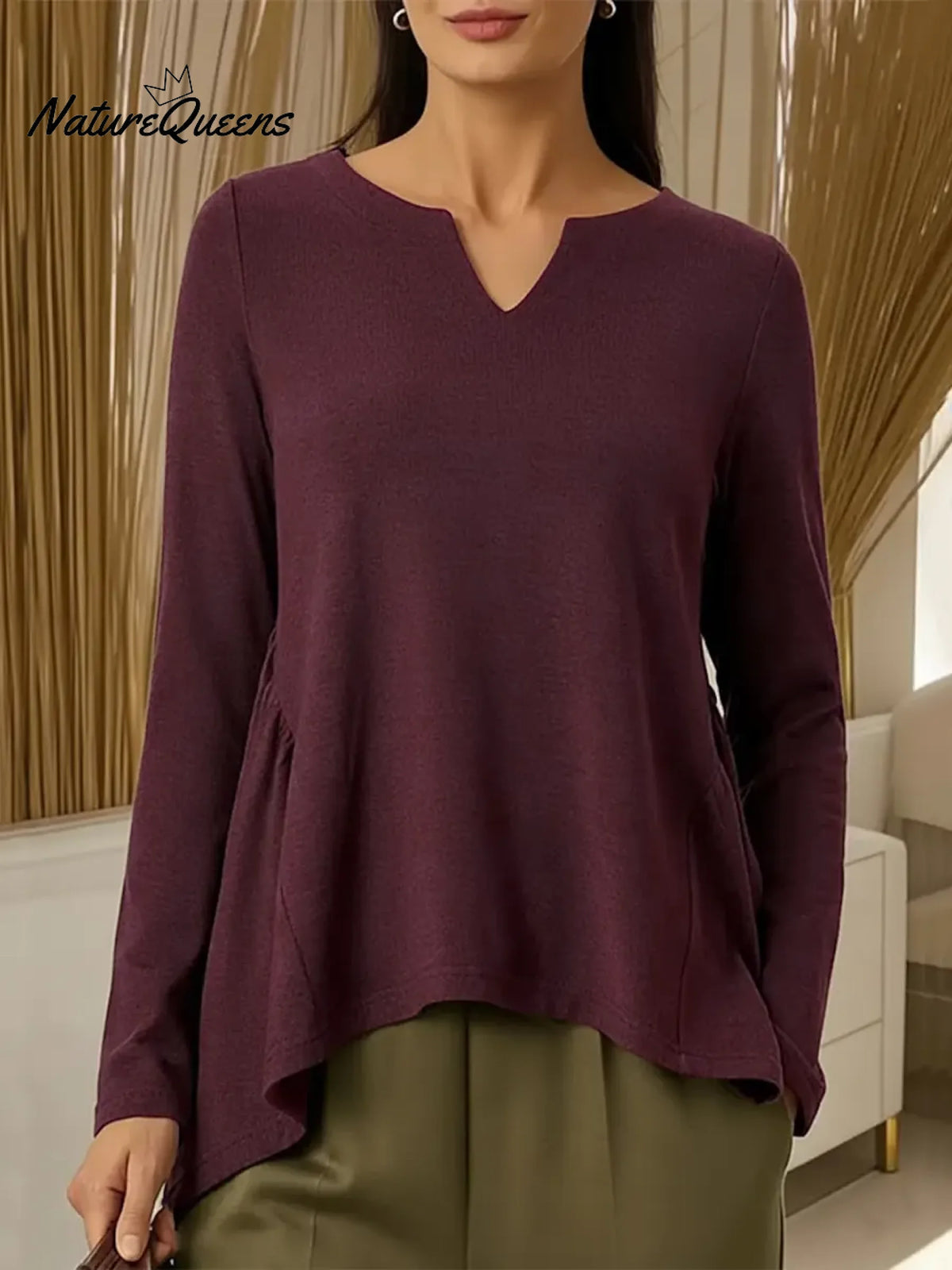 Women's Solid Color V-neck Long-sleeved Casual Loose-fitting Top With Irregular Hem.
