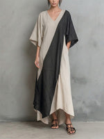 Long Cotton-linen Dress Featuring Diagonal Color-blocking, Batwing Sleeves, A V-neck, And An Asymmetrical Hem.