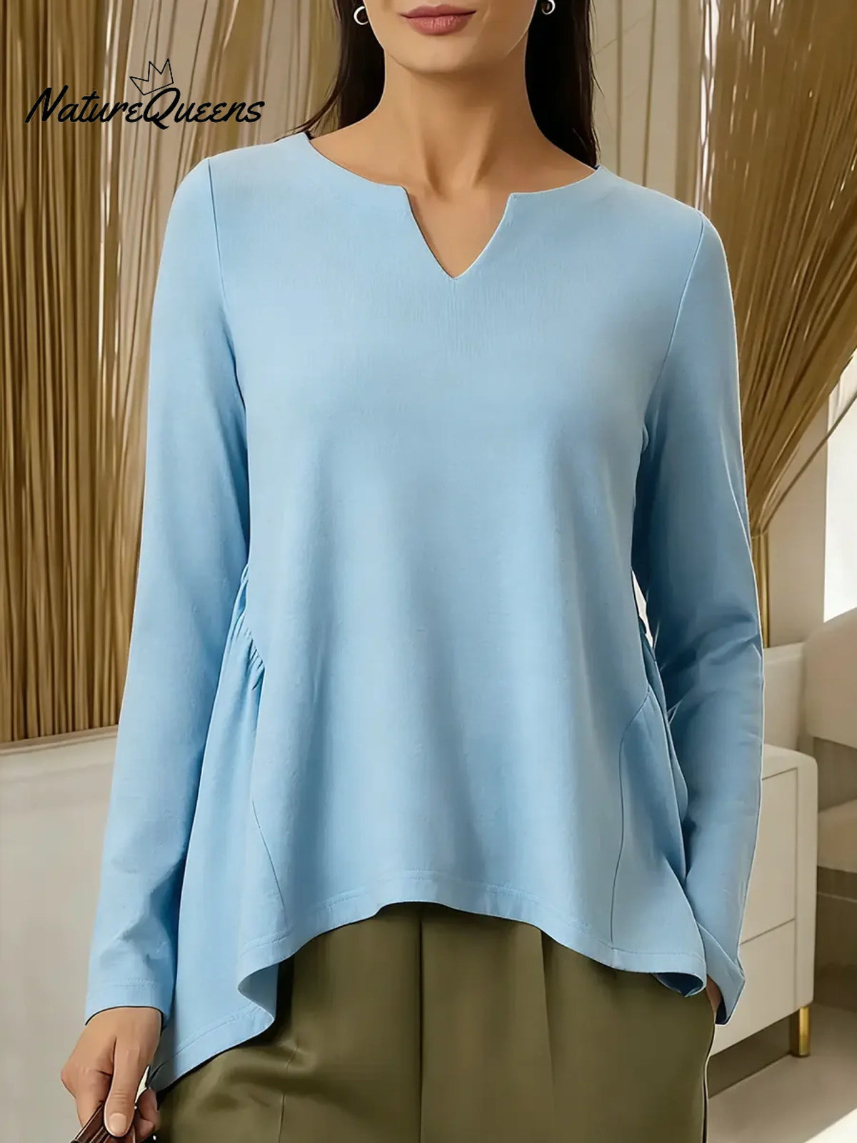 Women's Solid Color V-neck Long-sleeved Casual Loose-fitting Top With Irregular Hem.