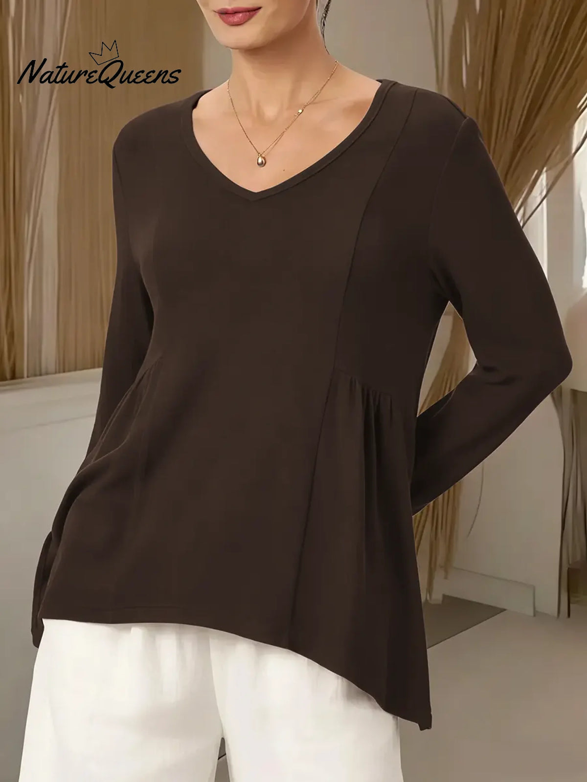 Women's Solid Color V-neck Long-sleeved Casual Loose-fitting Top With Irregular Hem.