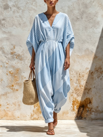 Vertical-striped V-neck Cotton Jumpsuit Featuring A Cinched Waist, Rolled Cuffs, And Loose-fitting Batwing Mid-length Sleeves.