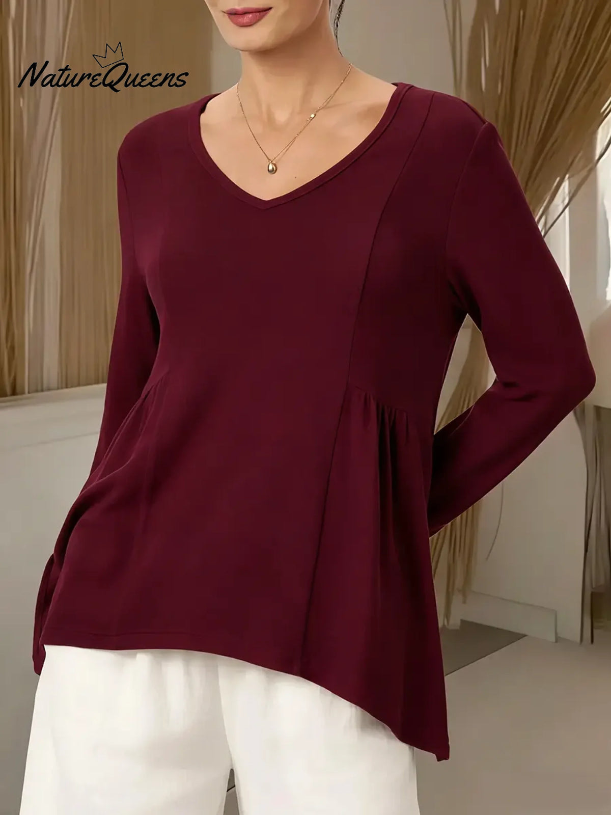 Women's Solid Color V-neck Long-sleeved Casual Loose-fitting Top With Irregular Hem.