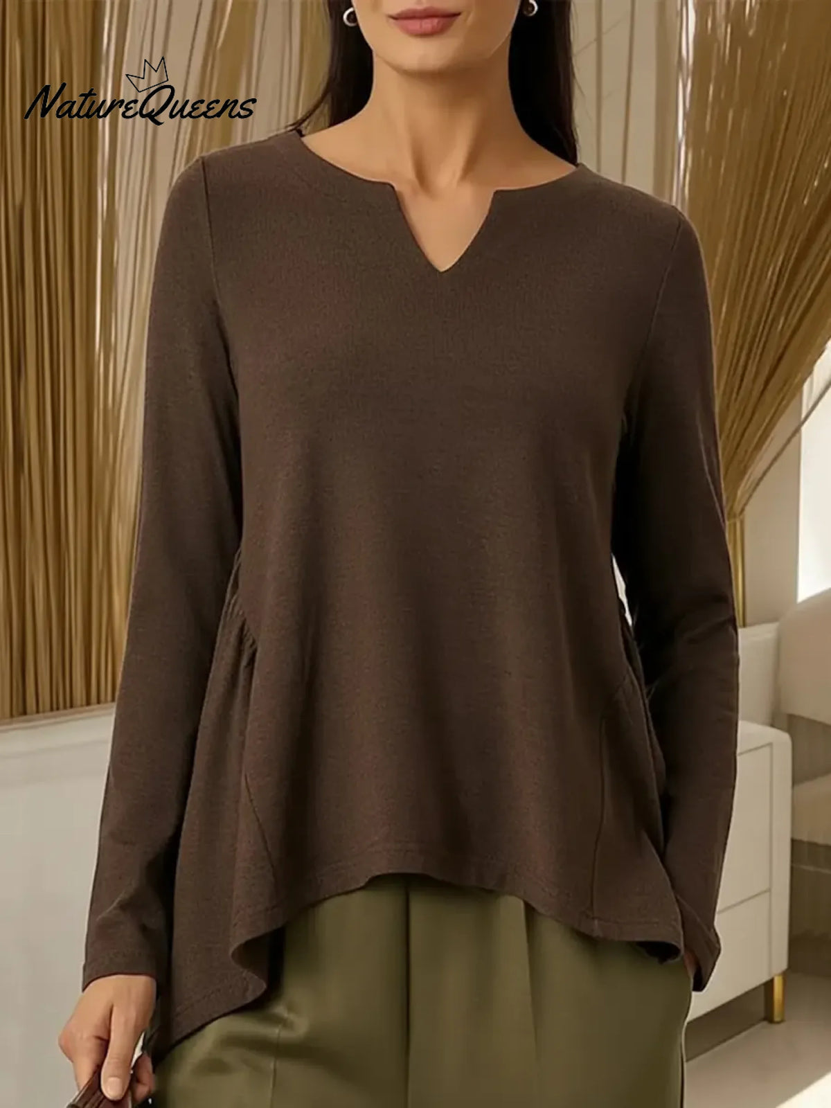 Women's Solid Color V-neck Long-sleeved Casual Loose-fitting Top With Irregular Hem.